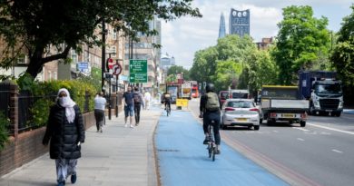 Cyclist riding on blue cycle lane in London