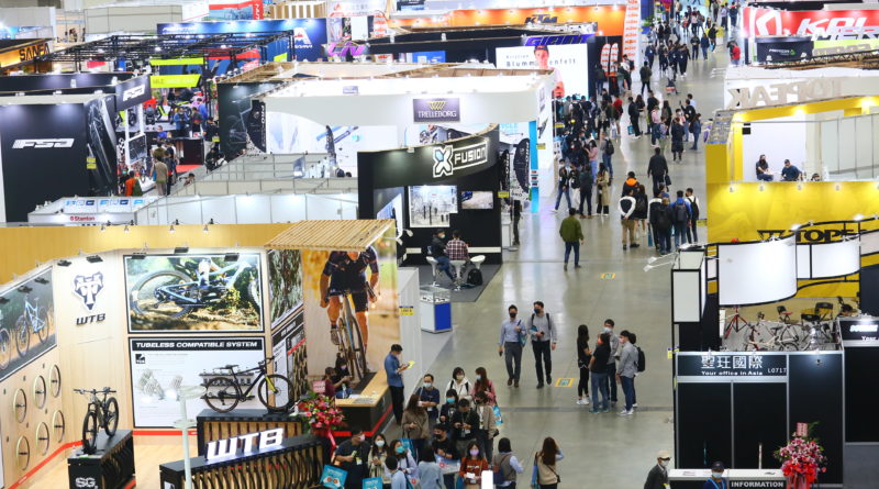 Taipei trade show hall with people walking between exhibitor stands