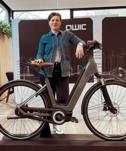 Amy Paillot stood with a QWIC bicycle
