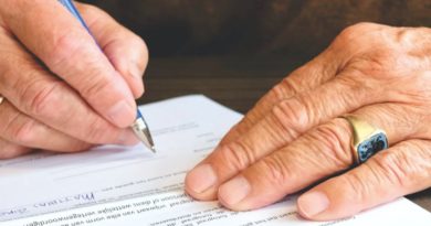 Close up of person signing contract