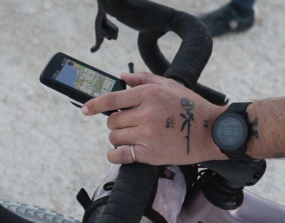 Hammerhead Karoo 2 mounted on outfront mount of handlebar with rider wearing Suunto watch on wrist