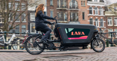 Dockr cargo bike with Laka logo on being ridden in an urban setting