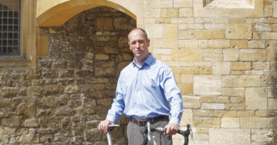 Mat Hubbard - COO - Moulton Bicycle Company stood with a Moulton bike across him