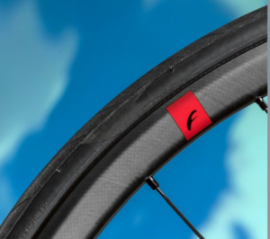 Close crop showing section of Fulcrum Speed 25 rim, inc tyre mounted, with graphic logo