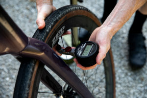 Truth Gauge being used to check tyre pressure on a gravel bike