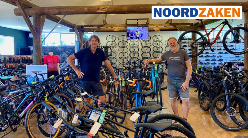 Bert and Luke Belga stood with a range of bikes in their now Broekhaus auto owned cycle store