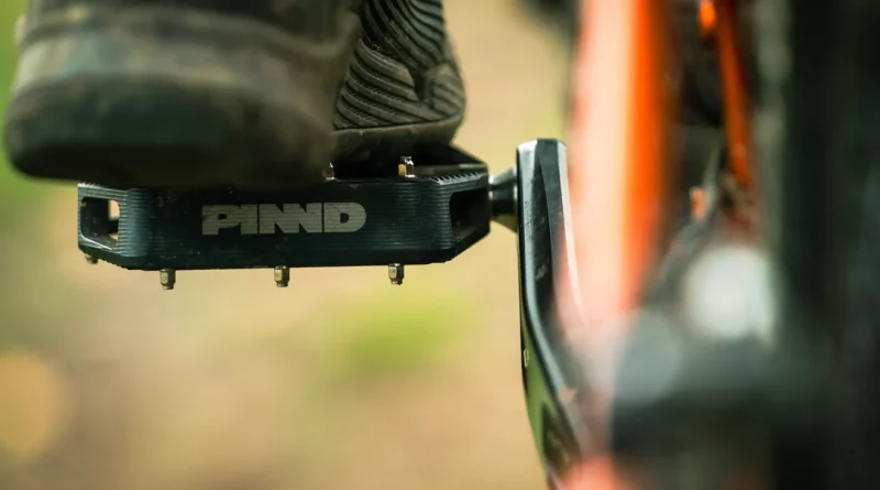 Close crop of foot resting on PINND pedal attached to MTB