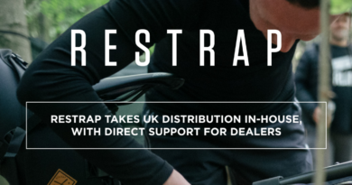 "Restrap takes UK distribution in-house" over image of person leaning over packing a frame bag