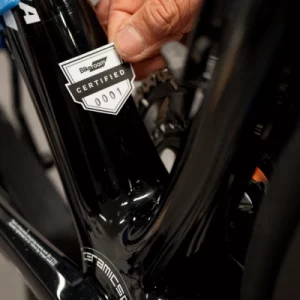 Certification sticker being applied to frame