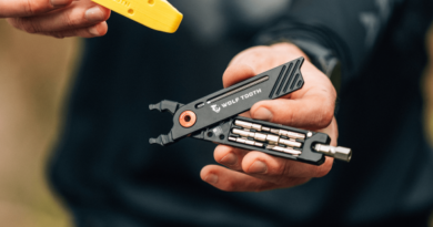 Wolftooth X Magura multitool collaboration. being held open in hands. Close crop of tools in parts