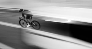 Oquo road bike black and white image of rider streaking past 