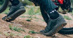 Close up of Leatt footwear on mountain bike trail 