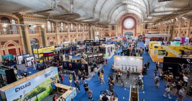 Overhead view of the exhibition hall with people walking the isles between cycling brands stands