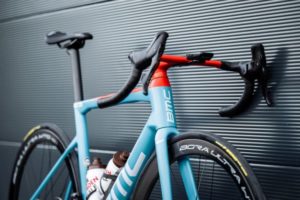 BMC AG2R Citroën Team bike forward facing at 45 degree angle, lent against wall, from axles up