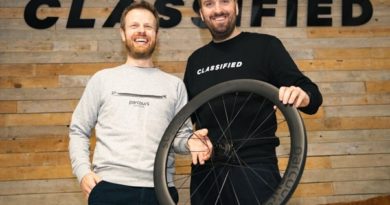 Classified Cycling and Parcours founders shake hands whilst holding wheel