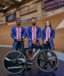 Members of Team USA track cycling squad stood with LOOK track bike at corner of velodrome banking