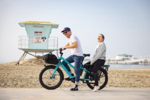 Cargo bike at the beach with 2 riders ready to pedal away