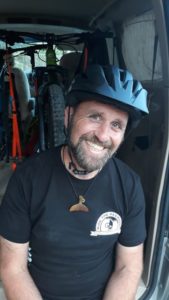 Bike Matrix Co-Founder Adam Townsend sat on the tailgate of a van with MTB in the back