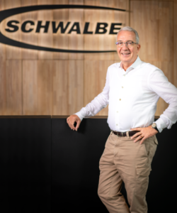 Frank Bohle profile picture stood by Schwalbe sign 