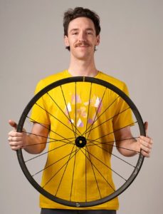 Jacob Hennessy holding Mavic wheel. Profile picture