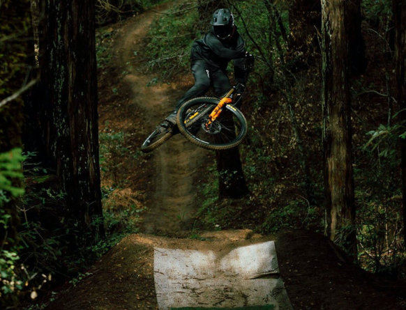 Ibis rider going big over a table top in woodland