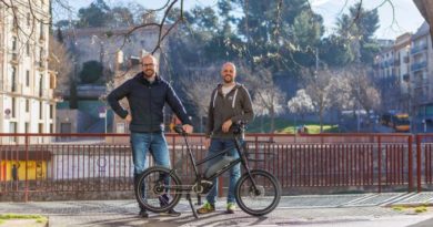 Niche Mobility co-founders stood with bike on street side in Girona