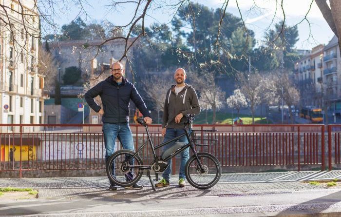 Niche Mobility co-founders stood with bike on street side in Girona