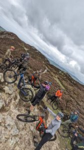 Group of eMTB riders paused mid ride on moorland