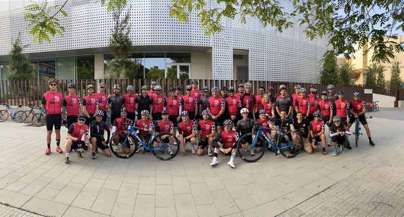 Assos global sales team group ride. Stood outside venue in Palma de Mallorca, in cycle kit, with bikes as a group.