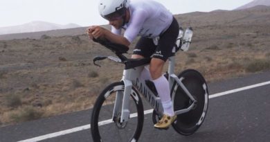 Ironman triathlete on bike in Compressport apparel