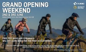Flyer showing 4 riders on bikes out in the wild, riding dusty trail with scorched grass and mountains in the background. Text overlay outlines Gloucester Cube store grand opening weekend detail