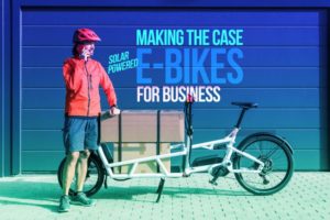 Solarcycle UK 'making eBikes better for business' text with eCargo bike and rider on foreground 