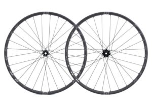 Reynolds new Blacklabel pro wheelset with front and rear overlapping in studio shot on white background