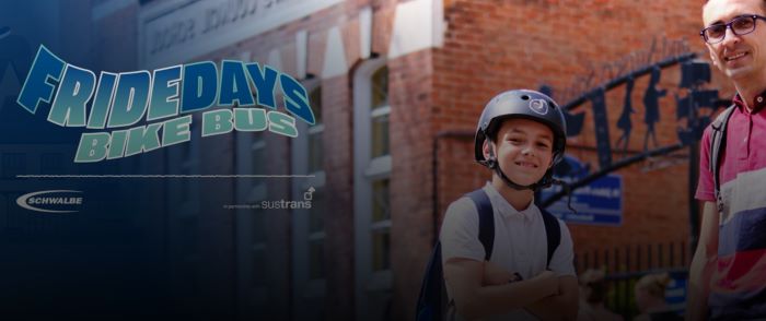 Fridedays Bike Bus banner image with school child in helmet stood with bike, and adult alongside
