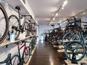 Eat Sleep Cycle bike retail space with bikes on walls and on elevated stands on the shop floor