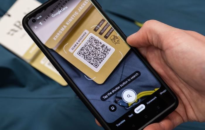 Mobile phone shown scanning QR code on Rab clothing label