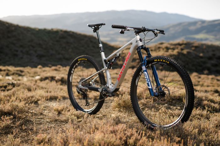 Santa Cruz bike fitted with new Rockshox SID and SIDLuxe fork and shock. Bike stood on moorland grass with hills in background