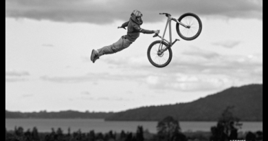 Specialized P Series with rider doing one hand superman. Greyish black and white image