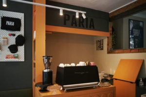 Paria cafe with espresso machine and grinder primed and ready