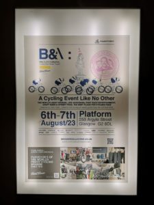 Poster for the B&A Collective event framed and hung on wall