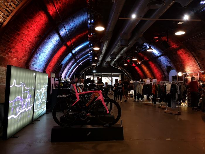 Wide shot of the B&A Collective venue with Pinarello and VB clothing on display on either side of the shot