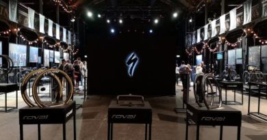 Specialized Tarmac SL8 launch. Wide view of location with brand stories of athletes and bikes on either side and product presentations in centre on stands