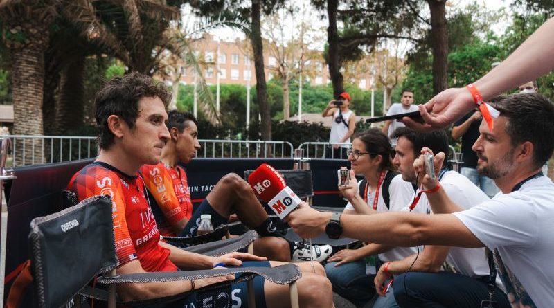Geraint Thomas doing media at the Vuelta. Riders from the team sat in chairs with journalists holding microphones to capture the interview