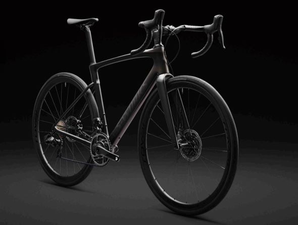 Specialized Roubaix 2023 studio shot on dark backdrop with bike at a 45 degree angle, drive side on, front wheel pointing toward right bottom corner of image