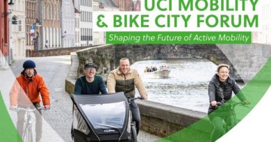 People riding urban bikes in regular clothing in a city setting with 'UCI Mobility and Bike City Forum' text overlay