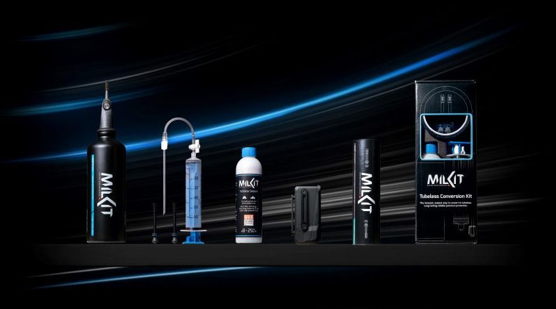 milKit product range stood on display with dark lighting and blue swoops on the black backdrop