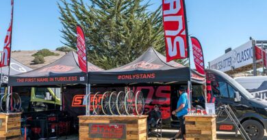 Stan's No-Tubes at bike event with gazebo and flags up